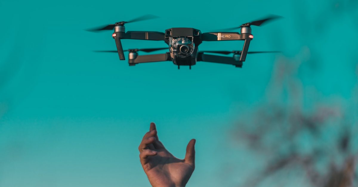 Hand reaching out to drone